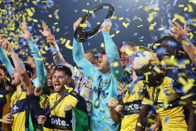 GOSFORD, AUSTRALIA - MAY 25: Danny Vukovic of the Central Coast Mariners holds aloft the Championship Trophy alongside team mates after winning the A-League Men Grand Final match between Central Coast Mariners and Melbourne Victory at Industree Group Stadium, on May 25, 2024, in Gosford, Australia. (Photo by Mark Metcalfe/Getty Images)