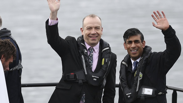 Britain’s Prime Minister and Conservative Party leader Rishi Sunak, right, and Britain’s Northern Ireland Secretary Chris Heaton-Harris wait on board an Artemis Technologies boat before a tour during a visit to the maritime technology centre at a dockyard in Belfast, on Friday.