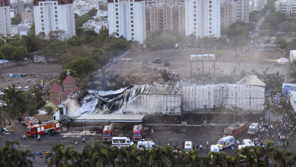 Firefighters douse a fire that broke out in a fun park, in Rajkot in the Indian state of Gujarat on Saturday.