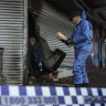 Police and arson investigators on the scene at another tobacco store arson attack in Hadfield last August.