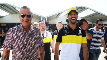 Singer Robbie Williams walks through the paddock with Daniel Ricciardo of Australia and Renault Sport F1 days before the Grand Prix 2020 in Melbourne which was ultimately cancelled.