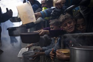 Palestinians line up for a free meal in Rafah, Gaza Strip, Friday, Feb. 16, 2024.