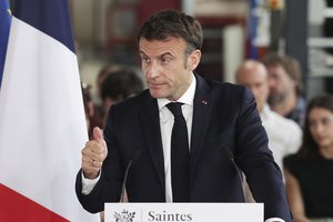 French President Emmanuel Macron reacts during a visit at a French professional highschool in Saintes, western France, Thursday, May 4, 2023