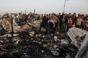 Palestinians look at the destruction after an Israeli strike where displaced people were staying in Rafah, Gaza Strip, Monday, May 27, 2024. Palestinian health workers said Israeli airstrikes killed at least 35 people in the area. Israel's army confirmed Sunday's strike and said it hit a Hamas installation and killed two senior Hamas militants.