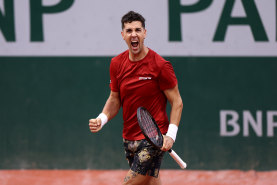 Thanasi Kokkinakis celebrates at Roland-Garros.