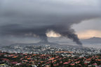 Smoke rises during protests in Noumea, New Caledonia.