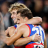 Lachlan McNeil of the Bulldogs (right) celebrates a goal with teammate Ryley Sanders.