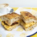 Cut Lunch Deli. Bacon, egg and cheese focaccia with chilli oil mayo. Randwick, August 23, 2022. Photo: Rhett Wyman/SMH .