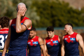 Skipper Max Gawn leads his beleaguered team off the field after their lamentable performance against Fremantle in Alice Springs.