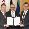 Health Minister Mark Butler, Prime Minister Anthony Albanese and Pharmacy Guild president Professor Trent Twomey during the signing of the new agreement on Monday.