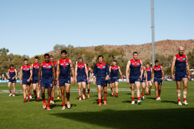 The dejected Demons traipse off Traeger Park in Alice Springs after Sunday’s 92-point loss. 