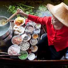 Damnoen Saduk Floating Market, Thailand - April 3, 2011: Food vendor at Damnoen Saduk Floating Market preparing Thai style noodles on a traditional boat. Many fresh ingredients are used and the overall combination of flavours is delicious. credit: istock
one time use for Traveller only