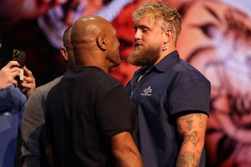 Mike Tyson shapes up to Jake Paul at a press conference.