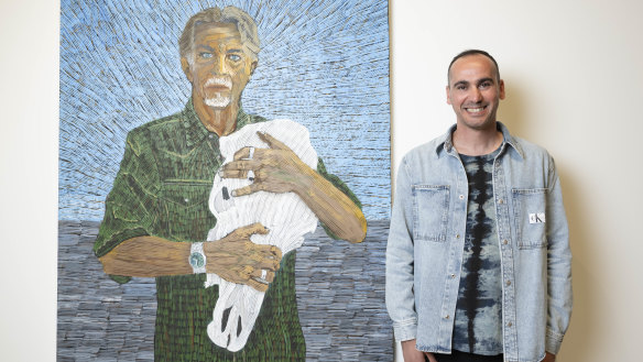 Former refugee Mostafa Azimitabar with his portrait of Angus McDonald, which is a finalist in the Archibald Prize at the Art Gallery of NSW.