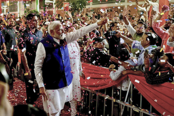 Prime Minister Narendra Modi is greeted by supporters as he arrives at his party’s headquarters in New Delhi.