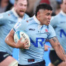Izaia Perese makes a break for the Waratahs against the Reds on Friday night.