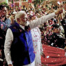 Prime Minister Narendra Modi is greeted by supporters as he arrives at his party’s headquarters in New Delhi.