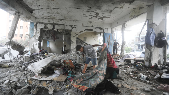 Palestinians look at the aftermath of the Israeli strike on a U.N.-run school that killed dozens of people in the Nusseirat refugee camp in the Gaza Strip, Thursday, June 6, 2024. (AP Photo/Ismael Abu Dayyah)