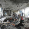 Palestinians look at the aftermath of the Israeli strike on a U.N.-run school that killed dozens of people in the Nusseirat refugee camp in the Gaza Strip, Thursday, June 6, 2024. (AP Photo/Ismael Abu Dayyah)