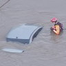 Helicopter footage shows a NSW State Emergency Service volunteer checking the car, which was almost entirely submerged on the Menangle Bridge. 