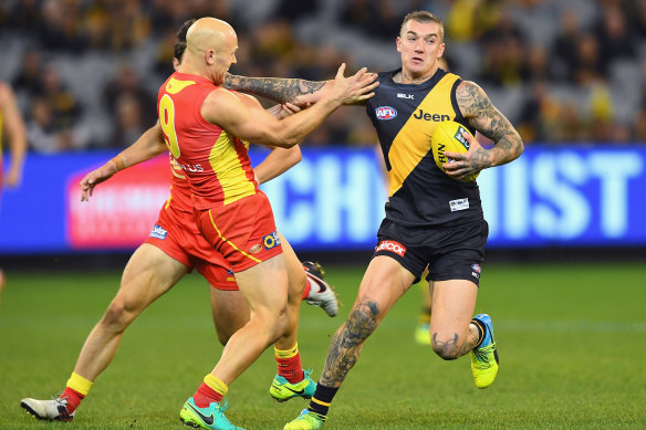 Richmond great Dustin Martin fends off Gold Coast and Geelong champion Dustin Martin.