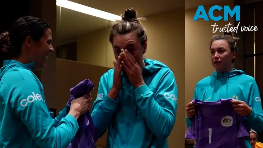 Matildas goalkeeper Lydia Williams presents team mate Mackenzie Arnold with the number one jersey.