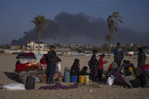 Palestinians who flee from Khan Younis from Israeli ground and air offensive on the Gaza Strip arrive in Rafah, southern Gaza, Monday, Jan. 22, 2024