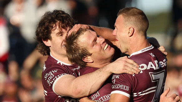 Jake Trbojevic and Daly Cherry-Evans celebrate a try against the Dragons on Sunday.