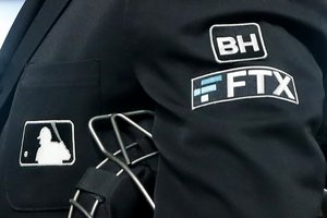 The FTX logo appears on home plate umpire Jansen Visconti's jacket at a baseball game