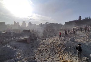 FILE - Palestinians inspect the damage of buildings destroyed by Israeli airstrikes on Jabaliya refugee camp on the outskirts of Gaza City on Oct. 31, 2023. Jabaliya refugee camp was one of Gaza’s most densely populated areas and has been struck multiple times since Oct. 7. The true toll remains unknown because many remain under the rubble.