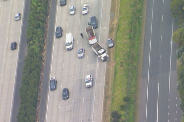 Police have taken a driver into custody after a truck was seen allegedly driving in a dangerous manner and swerving at cars in Queensland this afternoon.