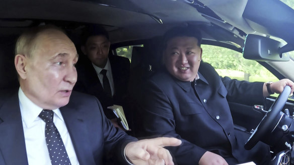 North Korean leader Kim Jong Un, drives a car which was presented by Russia’s President Vladimir Putin at a garden of the Kumsusan State Guest House in Pyongyang.