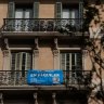 A banner reading ‘For Rent’ hangs from the balcony of a residential apartment near Plaza Catalunya in Barcelona.