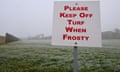 A sign altering to ‘keep off turf when frosty’ is seen in front of Parliament House in Canberra