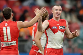 Chad Warner of the Swans celebrates with teammates.