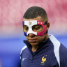 France’s Kylian Mbappe wears a face mask as he runs during a training session in Leipzig, Germany,