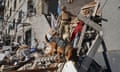 A rescue worker with a dog search for victims in a damaged apartment building after it was hit by Russian air bomb in Kharkiv, Ukraine