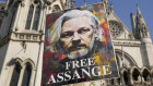 Protesters hold placards outside the High Court in London.