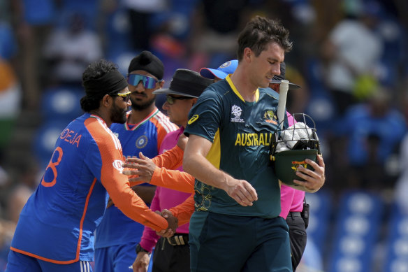 Pat Cummins walks off the field after Australia lost by 24 runs against India.