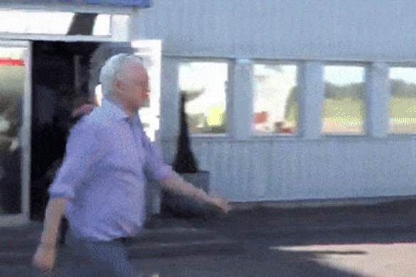 Julian Assange boards a plane at Stansted Airport in London after being given bail.