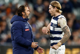 Chris Scott speaks with Cats star Tom Stewart in a break in play during Geelong’s clash with Carlton.
