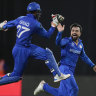 Afghanistan’s captain Rashid Khan is congratulated by teammate Mohammad Ishaq. 