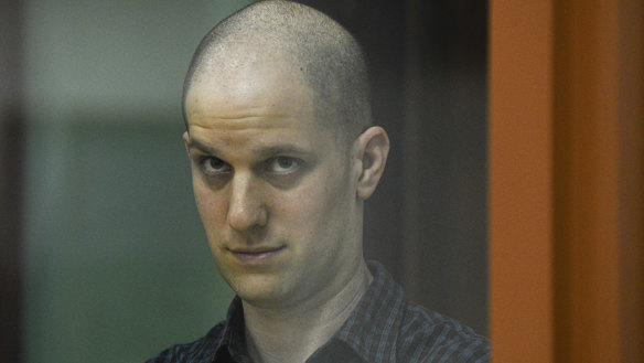 Wall Street Journal reporter Evan Gershkovich stands in a glass cage in a courtroom in Yekaterinburg, Russia.