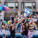 People take pictures in front of the Israel float