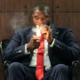 Wesley Hunt, left, and Byron Donalds, smoke cigars while speaking with host Sage Steele, right, at a "Congress, cognac and cigars" Republican event in Fairburn, Ga.