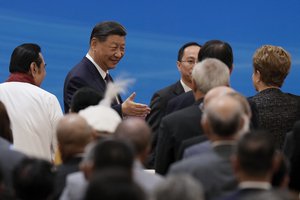 Chinese President Xi Jinping, center left, shakes hands with invited guests as he arrives at a conference marking the 70th anniversary of the Five Principles of Peaceful Coexistence at the Great Hall of the People in Beijing, Friday, June 28, 2024.