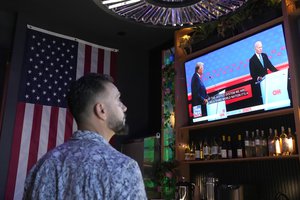 A patron watches President Joe Biden debate Republican presidential candidate and former President Donald Trump during a debate watch party Thursday, June 27, 2024, in Scottsdale, Ariz.