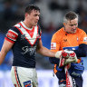 Joey Manu leaves the field with a suspected broken hand.