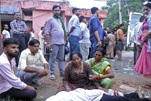 Women mourn next to the body of a relative outside the Sikandrarao hospital in Hathras district about 350 kilometers (217 miles) southwest of Lucknow, India, Tuesday, July 2, 2024. At least 60 people are dead and scores are injured after a stampede at a religious gathering of thousands of people in northern India, officials said Tuesday.