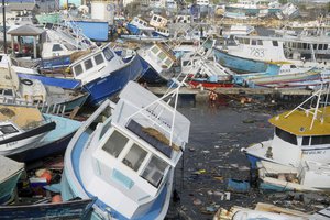 Fishing vessels damaged by Hurricane Beryl sit upended at the Bridgetown Fisheries in Barbados, Monday, July 1, 2024.